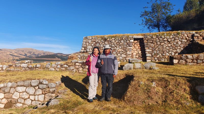 A Peruvian woman stands with a porter on a trek in Peru