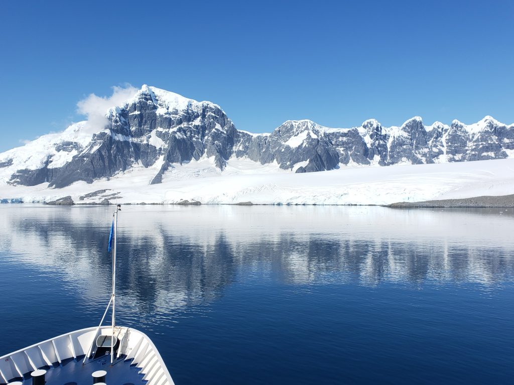 The view of snow-covered mountains and icy water from a ship