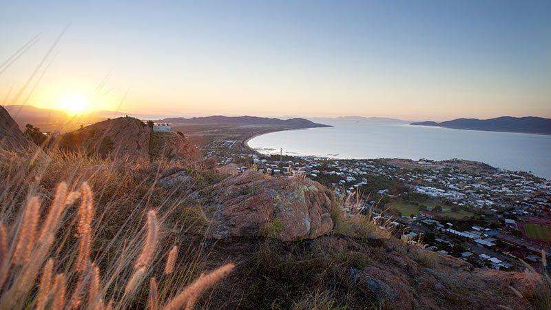 Aerial view of the town of Townsville and the surrounding coast at sunset. 