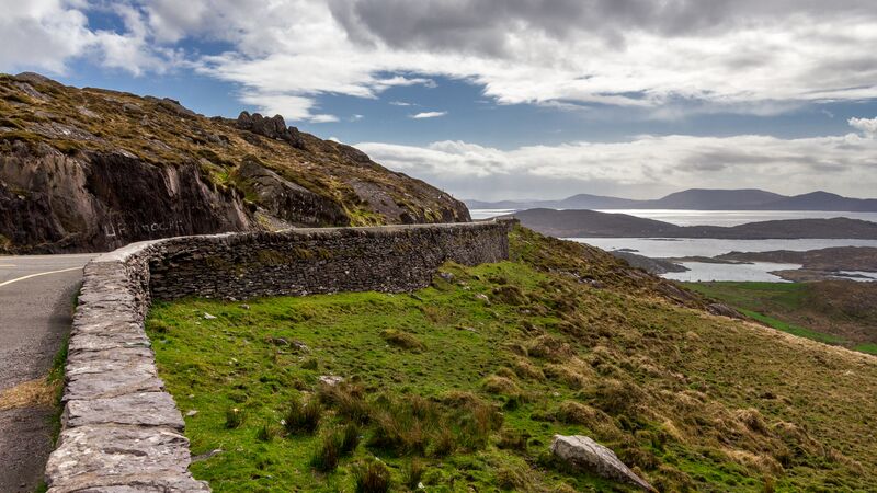 The Ring of Kerry landscape in Ireland under a cloudy sky.