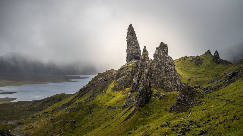 The towering pinnacles of rock among a mountain of green grass known as the Old Man of Storr, Scotland. 