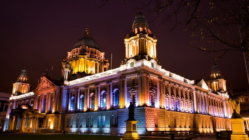 The City Hall in Belfast colourfully lit up at night.