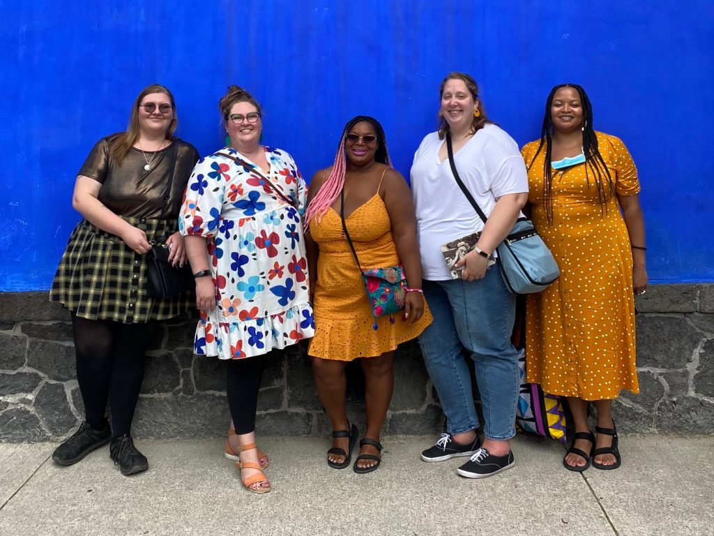 Five women standing in front of a blue wall in Mexico