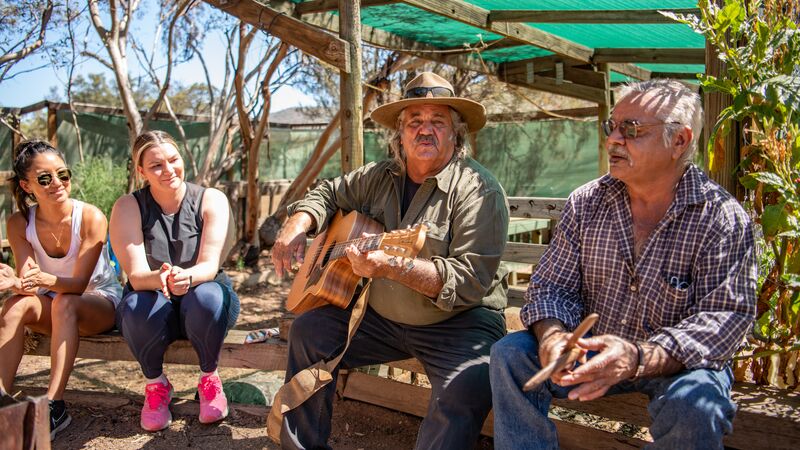 Two Aboriginal elders performing a song as part of a First Nations experience in South Australia. 