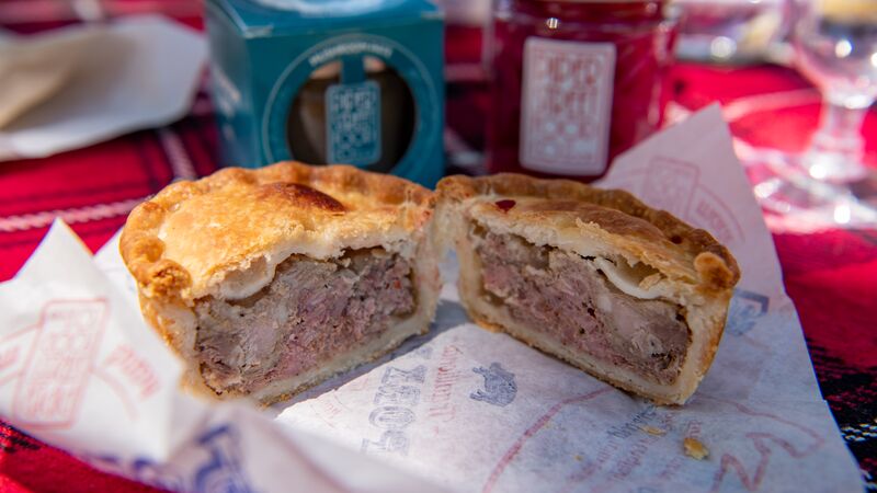 A flaky, golden meat pie cut in half