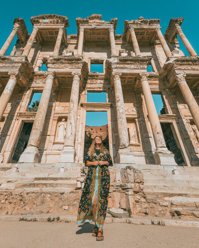 A woman standing in front of ancient ruins in Turkey