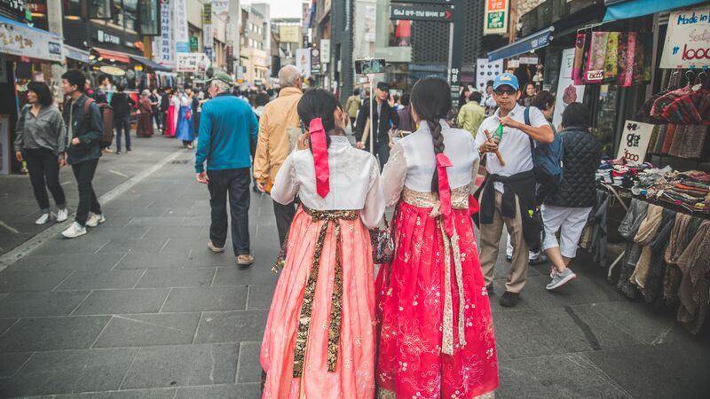 Two local women walking the streets in traditional costume.