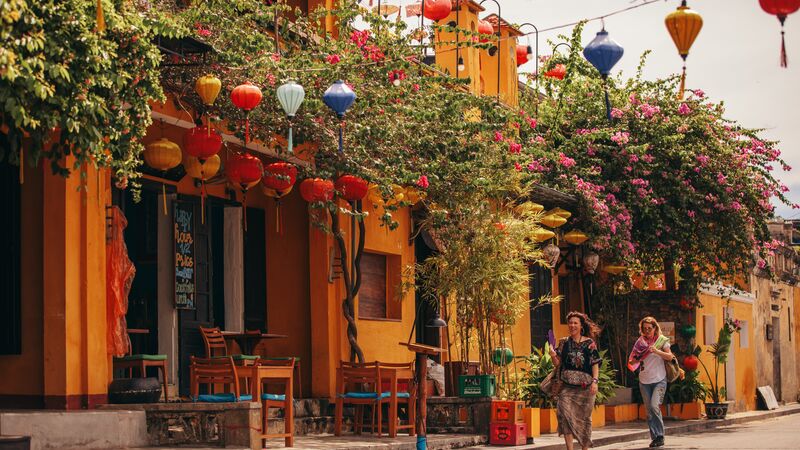 The colourful streets of Hoi An with lanterns hanging above the street. 