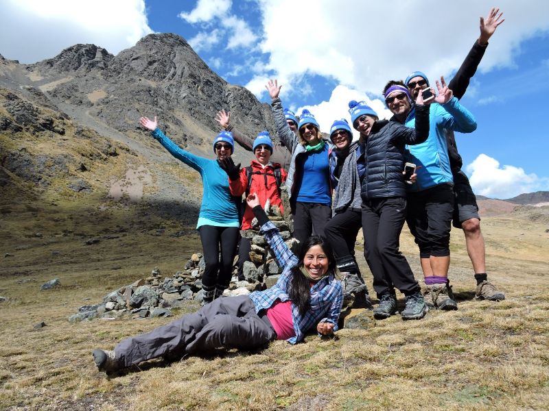 A small group of happy hikers on a mountain in Peru