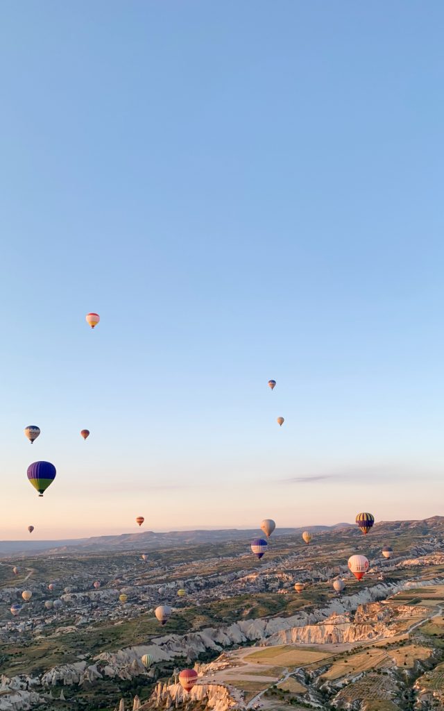 Hot air balloons flying over Cappadocia, Turkey at sunrise