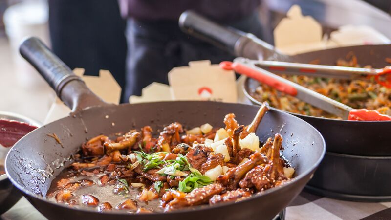 Ingredients being cooked in a wok in Malaysia. 