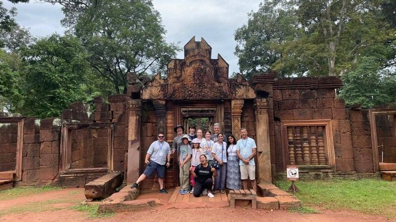 A group of travellers at a temple in Cambodia
