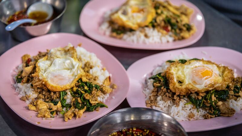 Plates of pad kra pao in Bangkok