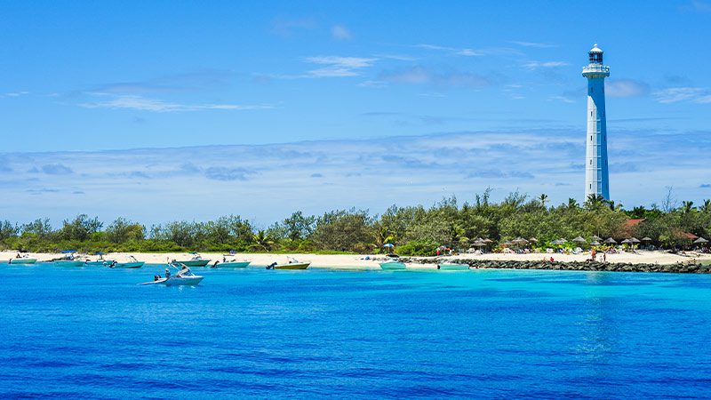The sparkling blue water of Amedee island with the lighthouse in the background. 