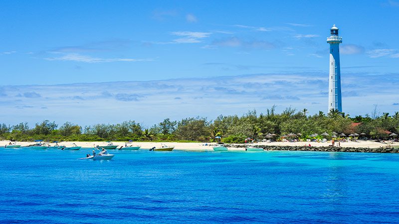 The sparkling blue water of Amedee island with the lighthouse in the background.