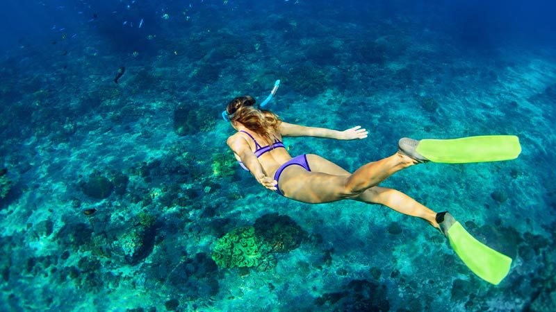 Woman snorkelling in the turquoise waters around Vanuatu. 