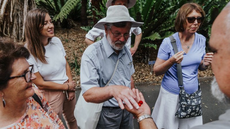 A group of travellers sampling Australian bush foods