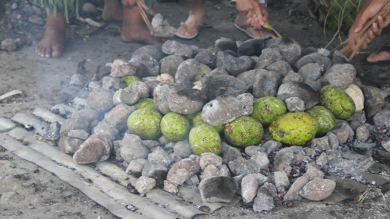 An umu (earth oven) in Samoa