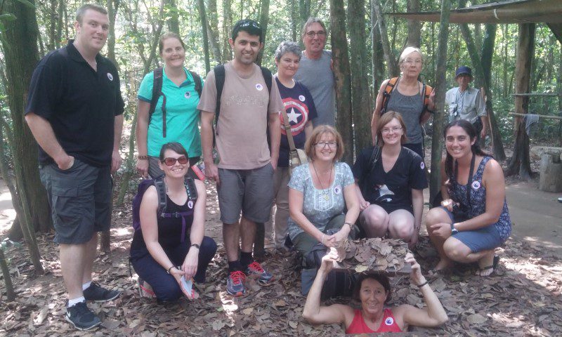 An Intrepid group pose at Cu Chi Tunnels, Vietnam