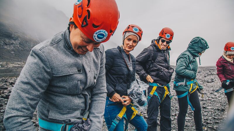 A group of travellers with harnesses on getting ready to hike the Vatnajokull glacier in Iceland.