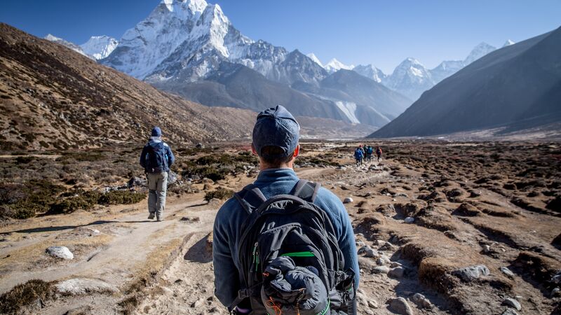 A hiker admiring the view of Mt Everest on the Everest Base Camp trail