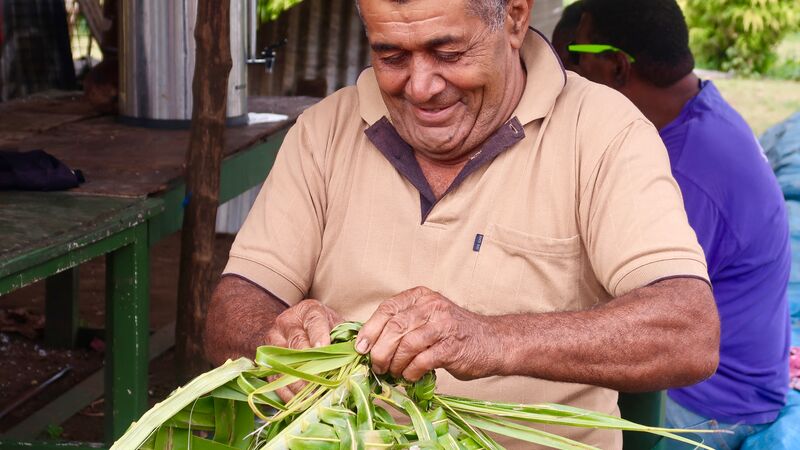 A Fijian weaving a basket the traditional way