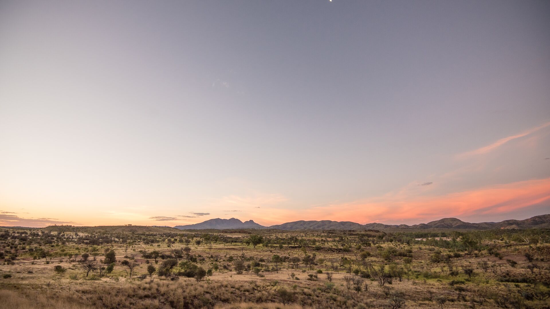 A wide shot of the sunset across the West MacDonnell Ranges.