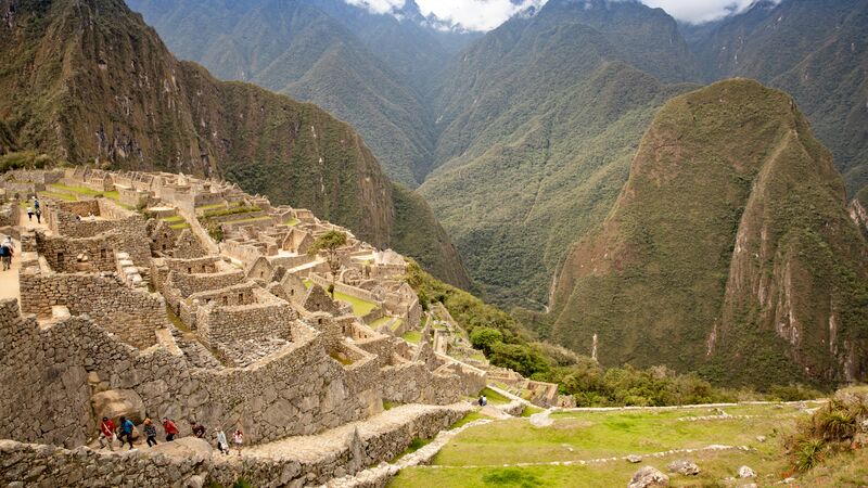 The intricate ruins of Machu Picchu sitting between mountain ranges in Peru.