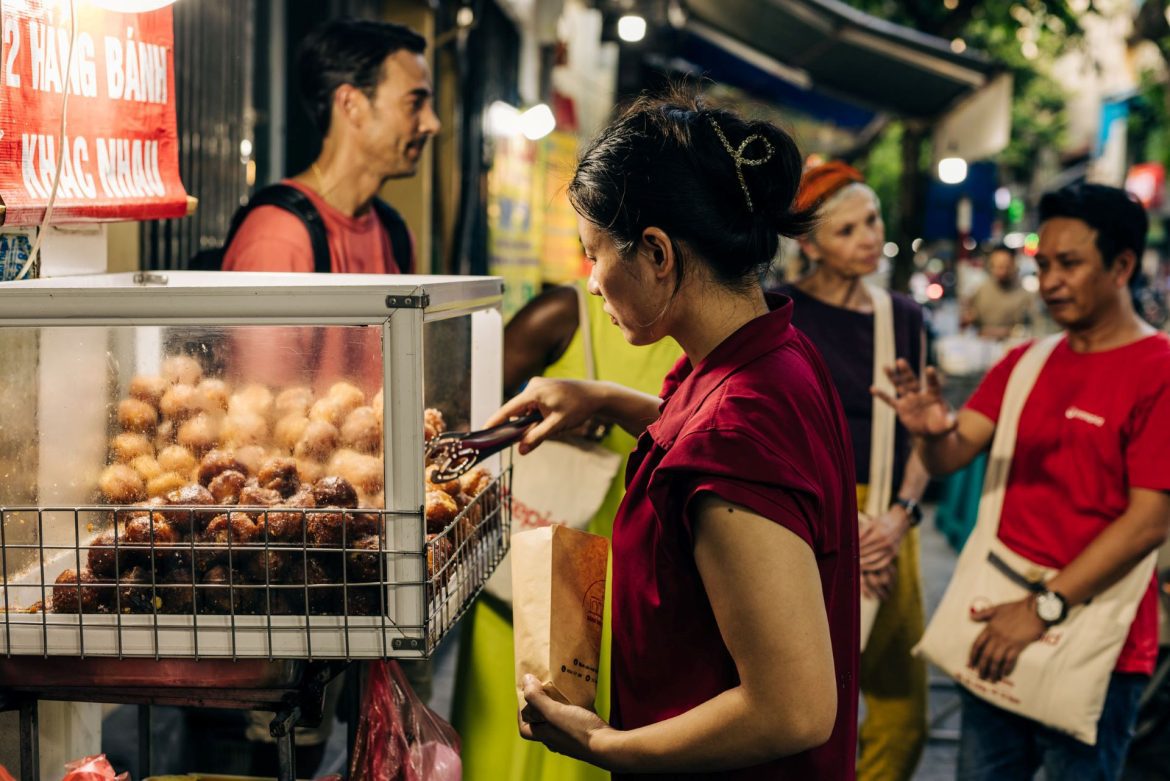 a Hanoi market vendor serving food