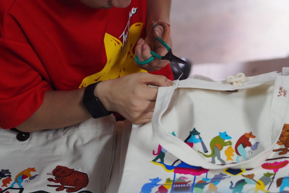 an artist making tote bags