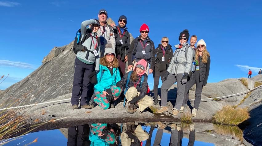 A group of travellers posing for a photo on Mt Kinabalu