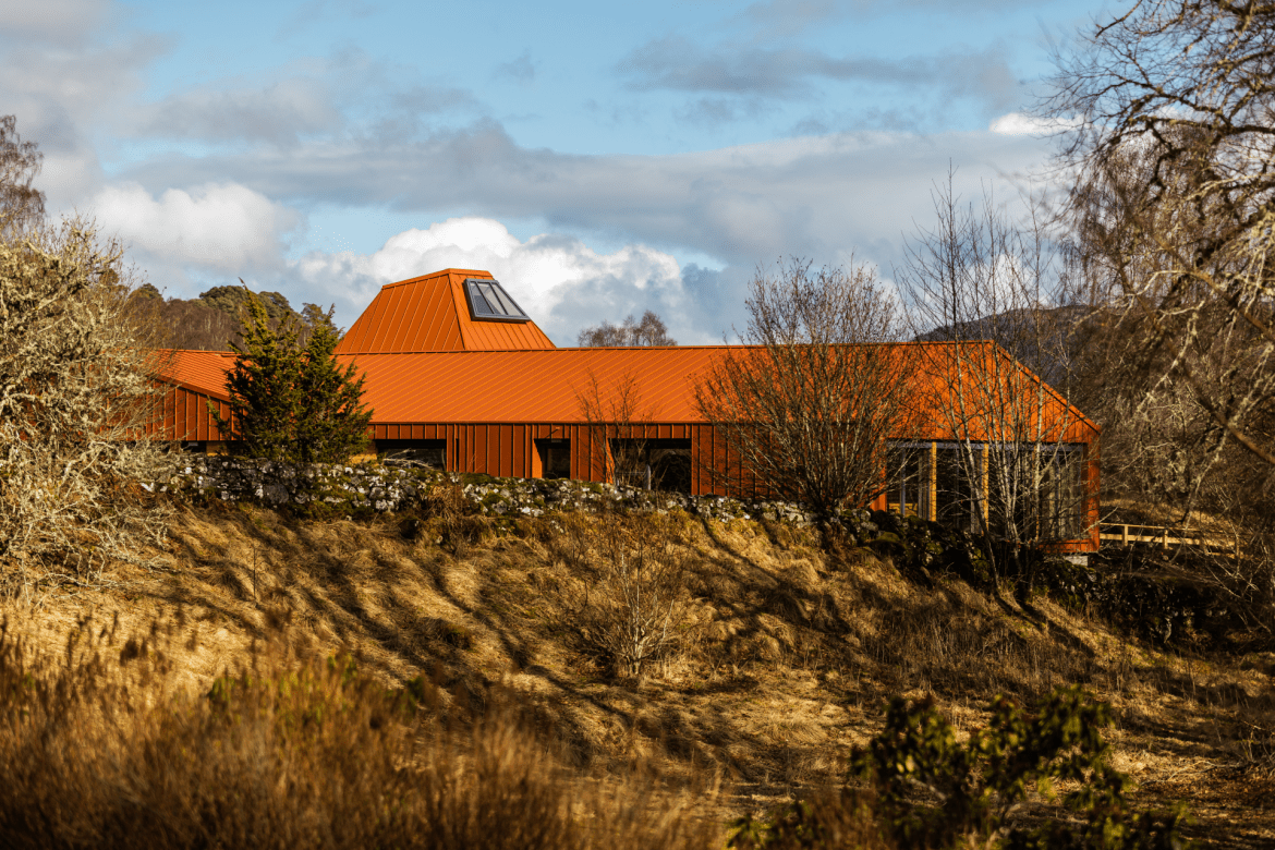 a red roofed conservation centre surrounded by trees