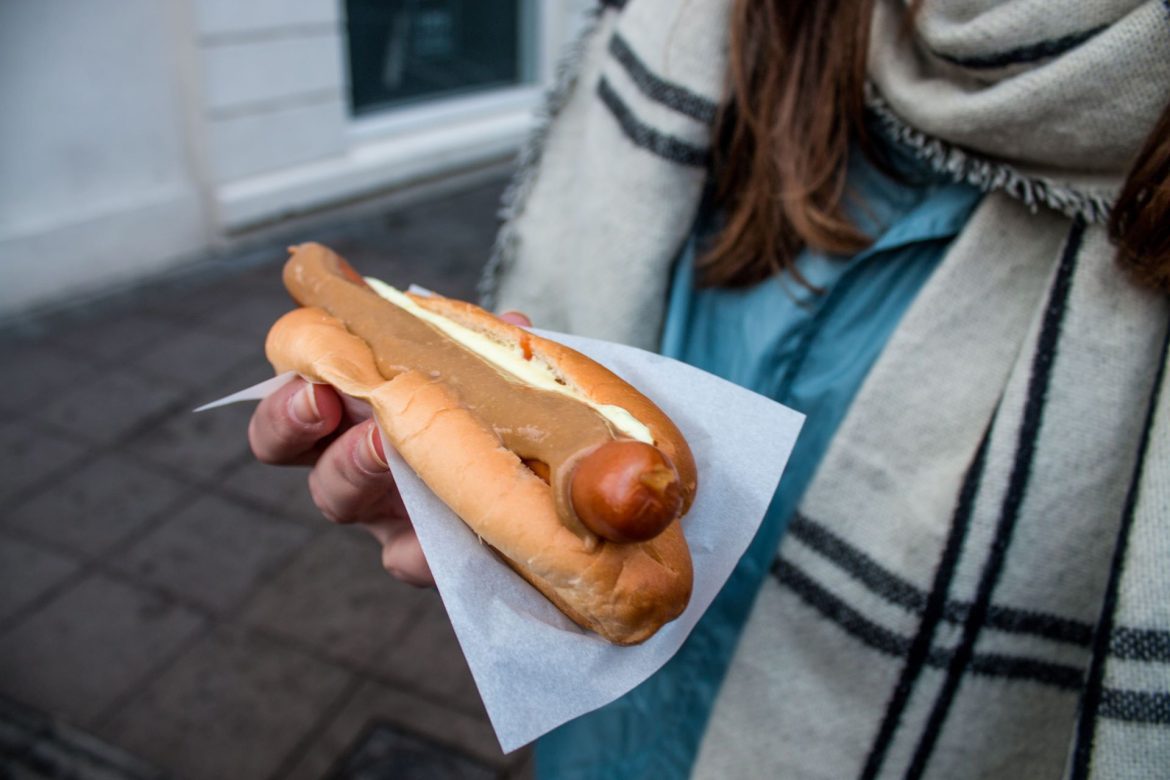 a woman holding an hotdog
