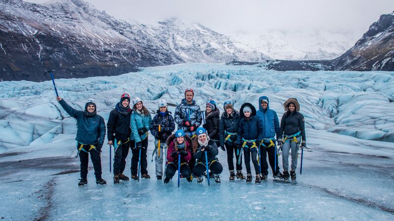 A group of travellers standing on an icy part of the Vatnajokull Glacier in Iceland. 