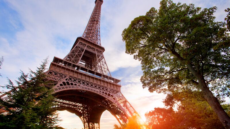 The beautiful framework of the Eiffel Tower in Paris at sunset. 