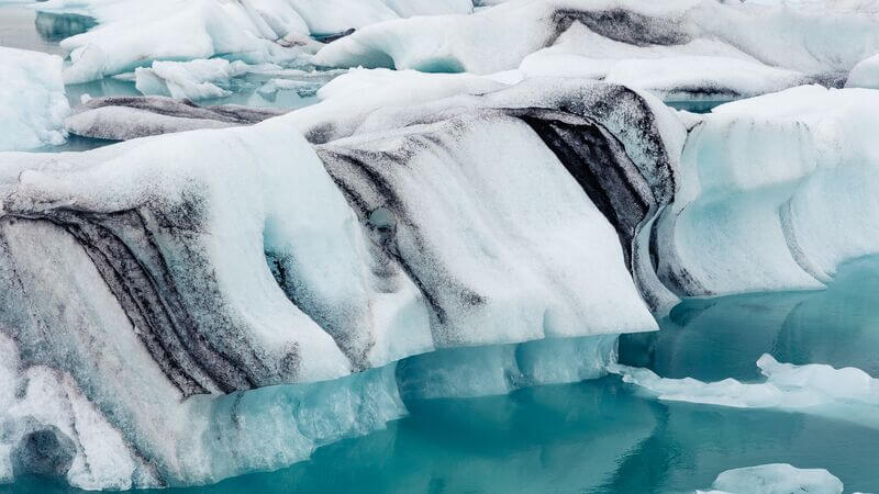excursions to iceland Black and white striped glacier at the Jokulsarlon Glacier Lagoon, Iceland