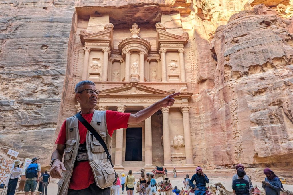 An Intrepid trip leader in front of Petra's treasury
