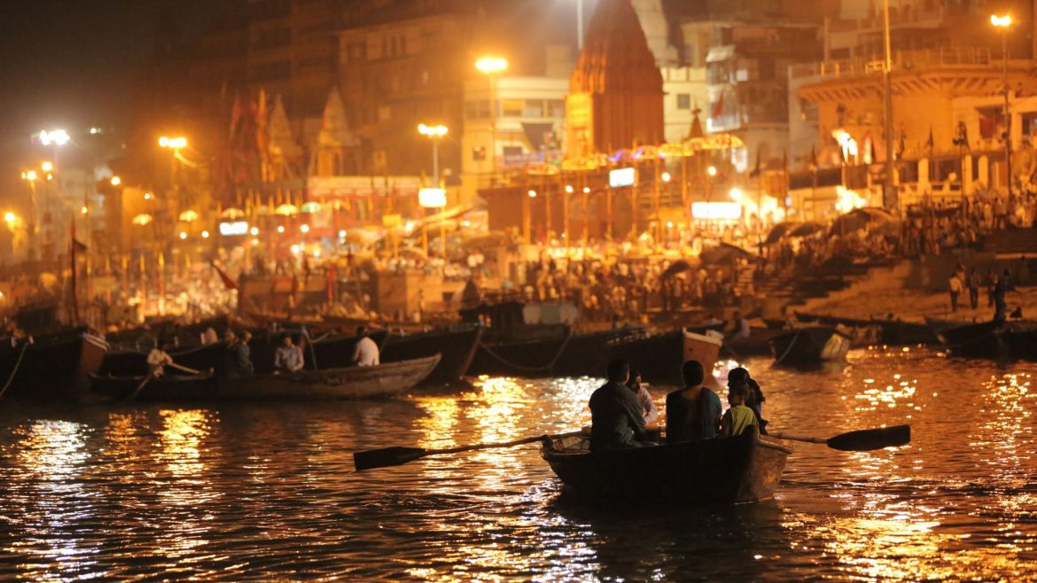 a boat on the water at night in Varanasi