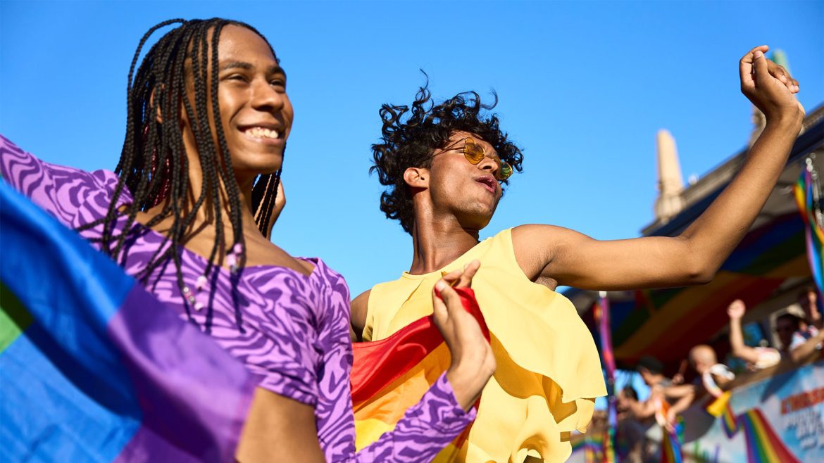 two people celebrating Pride by dancing joyfully