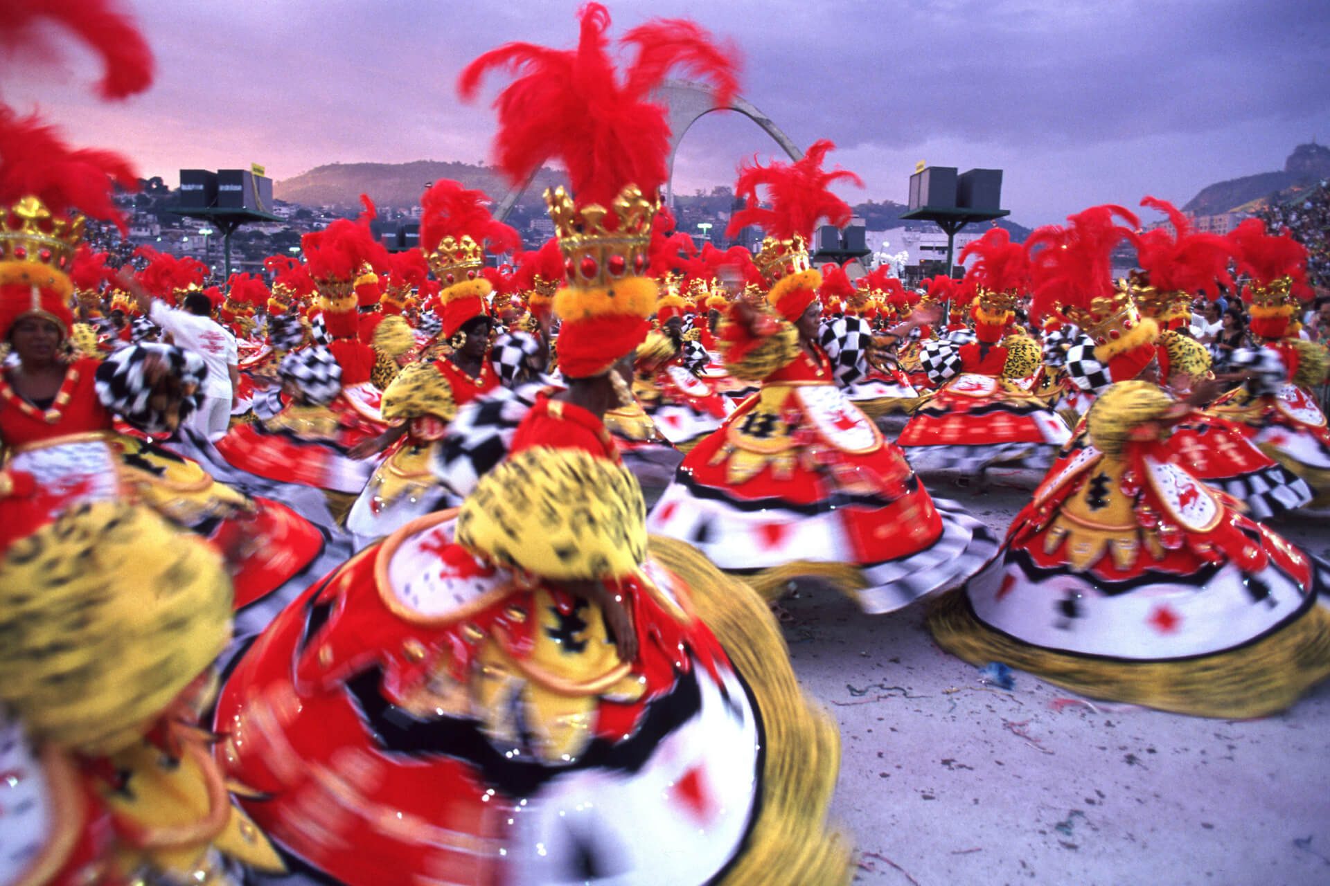 Women at Carnival twirling in traditional black, yellow, red and white dress, Brazil