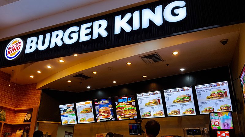 A Burger King storefront with menu items on display. 