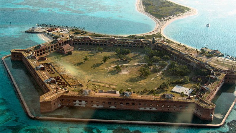 Fort Jefferson with its fort walls, surrounded by turquoise waters. 