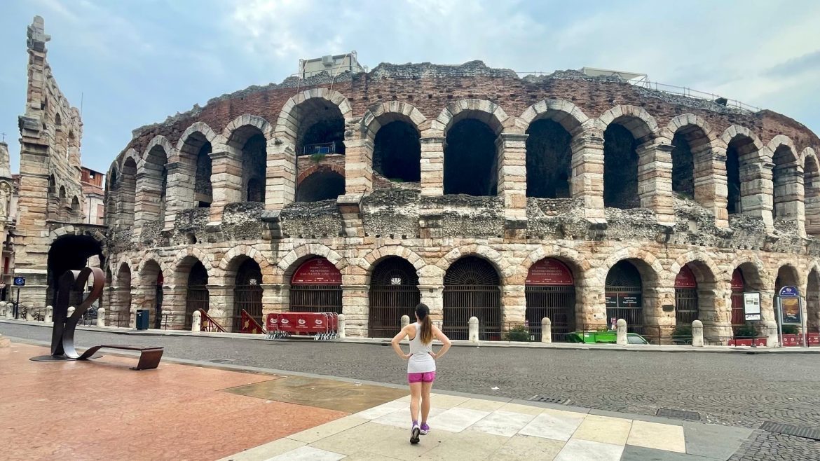 a woman standing in front of the Verona Arena