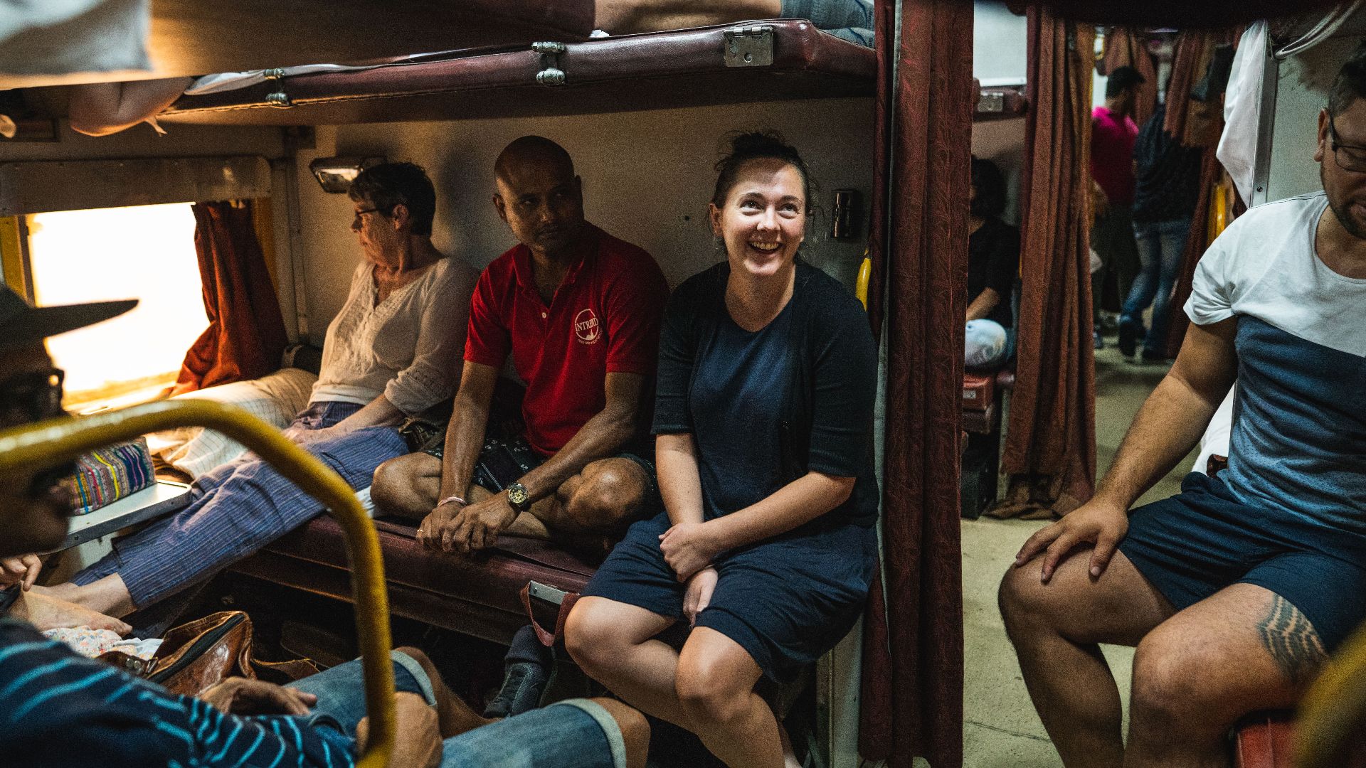 Inside an Indian train cabin with Intrepid. 
