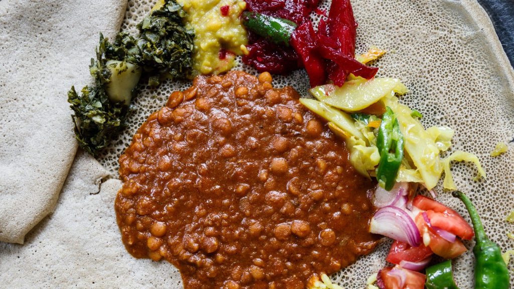 A plate of traditional Ethiopian food on injera (flatbread)