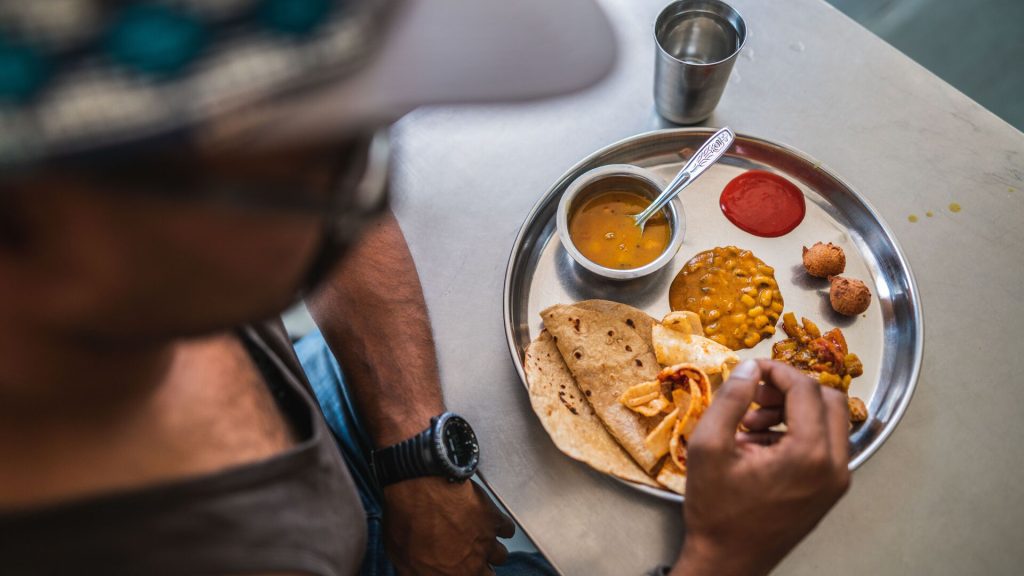 A traveller eating a traditional lunch in Udaipur, India