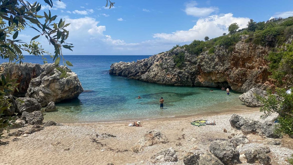 A man stand in knee-deep water in a coastal bay