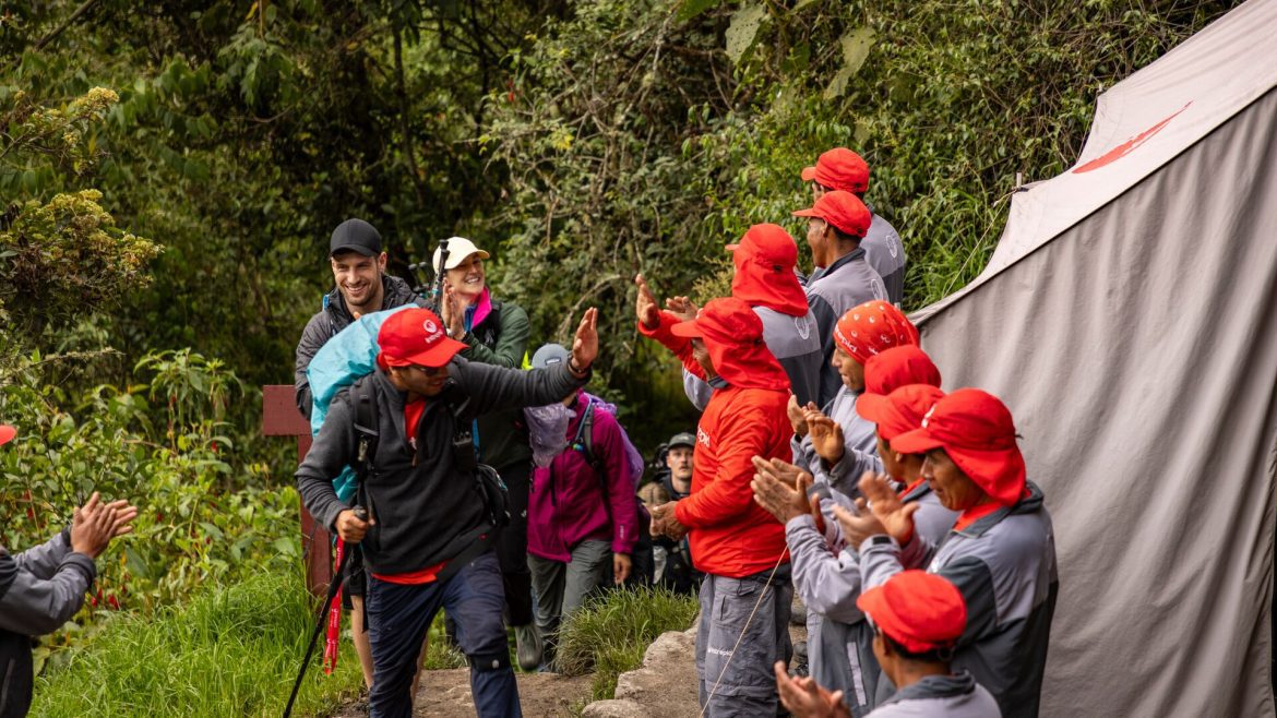An Intrepid crew welcomes Inca Trail trekkers to camp.