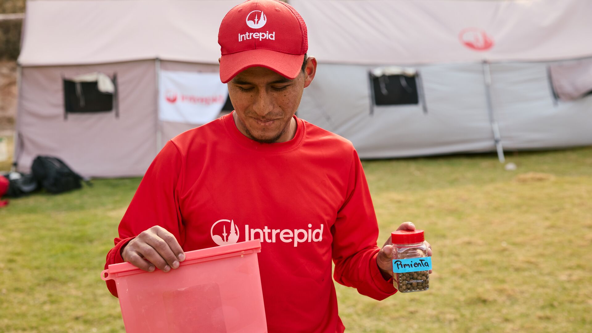 Trek supervisor Robert Franco showing off some of the reusable containers in use on Inca Trail treks.