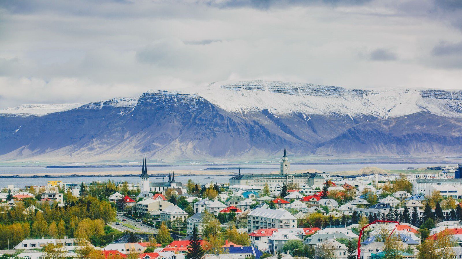 Reykjavik backdropped by snow-dusted mountains